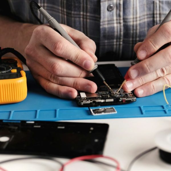 master-in-electronics-repair-service-center-fixing-smartphone.jpg